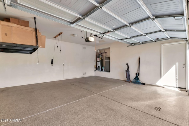 garage featuring water heater and a garage door opener