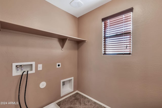 clothes washing area featuring electric dryer hookup, hookup for a washing machine, and tile patterned flooring