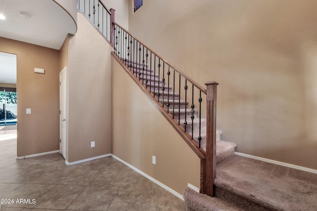 stairs with tile patterned floors