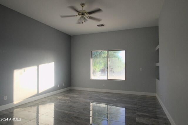 unfurnished room with ceiling fan and tile patterned floors