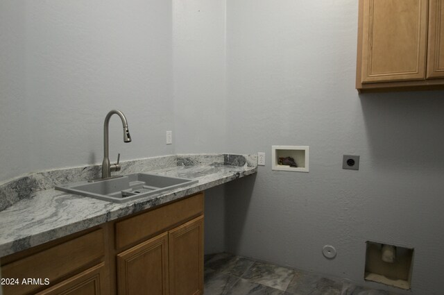 laundry room featuring hookup for a washing machine, hookup for an electric dryer, sink, gas dryer hookup, and cabinets