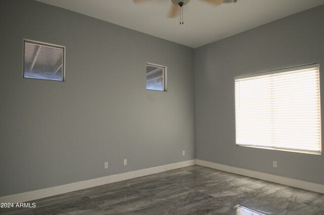 spare room with a wealth of natural light and ceiling fan