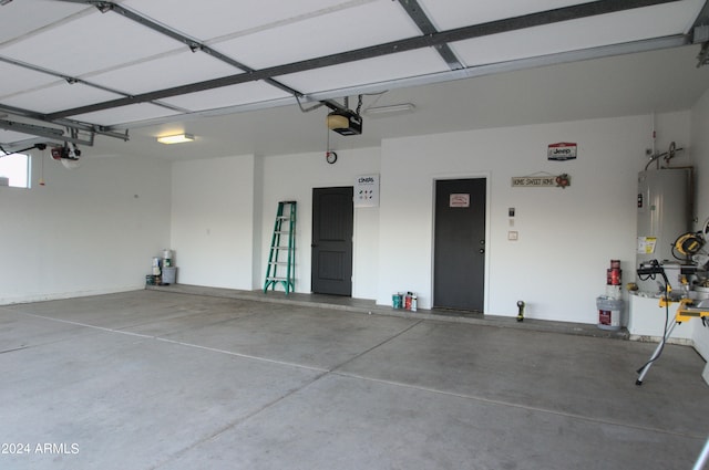 garage featuring a garage door opener and water heater