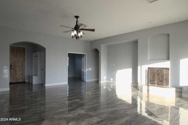 unfurnished living room featuring ceiling fan