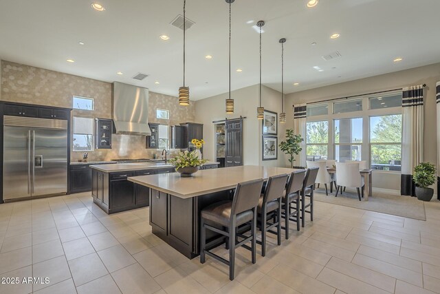 8768 E Granite Pass Rd, Scottsdale, AZ 85266 - kitchen featuring light countertops, exhaust hood, a spacious island, visible vents, and appliances with stainless steel finishes