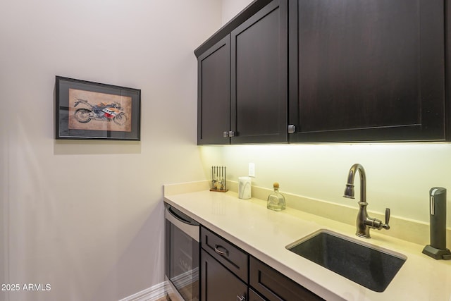 8768 E Granite Pass Rd, Scottsdale, AZ 85266 - kitchen featuring baseboards, light countertops, a sink, and wine cooler