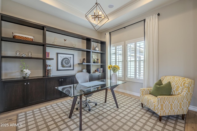 8768 E Granite Pass Rd, Scottsdale, AZ 85266 - office area with a chandelier, light wood finished floors, baseboards, ornamental molding, and a raised ceiling