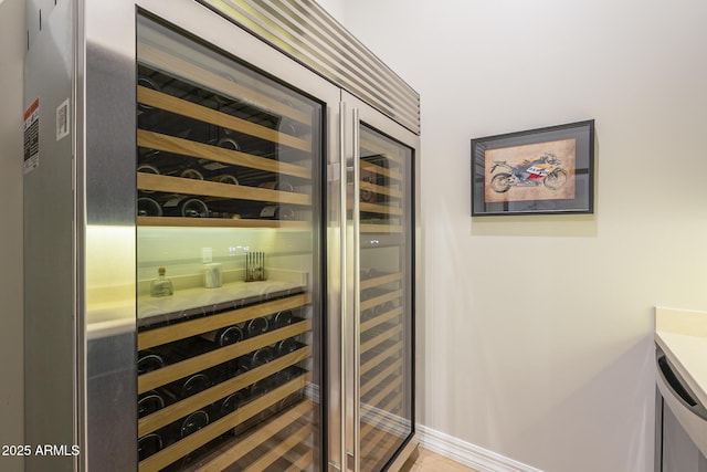8768 E Granite Pass Rd, Scottsdale, AZ 85266 - wine room featuring baseboards and wine cooler