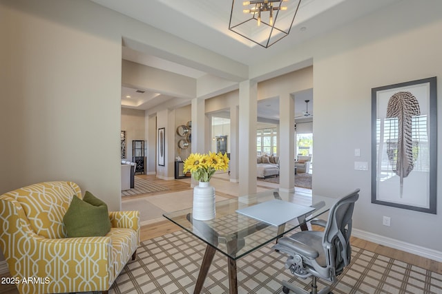 8768 E Granite Pass Rd, Scottsdale, AZ 85266 - dining area with baseboards, light wood-type flooring, a notable chandelier, and a raised ceiling