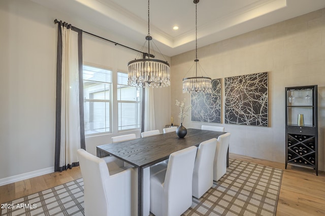8768 E Granite Pass Rd, Scottsdale, AZ 85266 - dining area with a notable chandelier, crown molding, a raised ceiling, light wood-style flooring, and recessed lighting