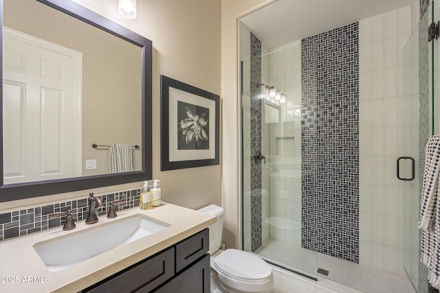 8768 E Granite Pass Rd, Scottsdale, AZ 85266 - bathroom with toilet, vanity, tasteful backsplash, and a stall shower