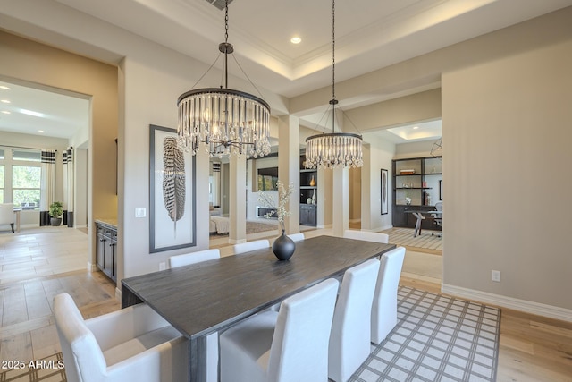 8768 E Granite Pass Rd, Scottsdale, AZ 85266 - kitchen featuring decorative light fixtures, a tray ceiling, light wood-type flooring, baseboards, and a chandelier