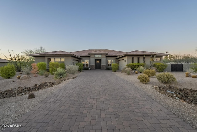 8768 E Granite Pass Rd, Scottsdale, AZ 85266 - prairie-style home with stucco siding, a garage, and decorative driveway