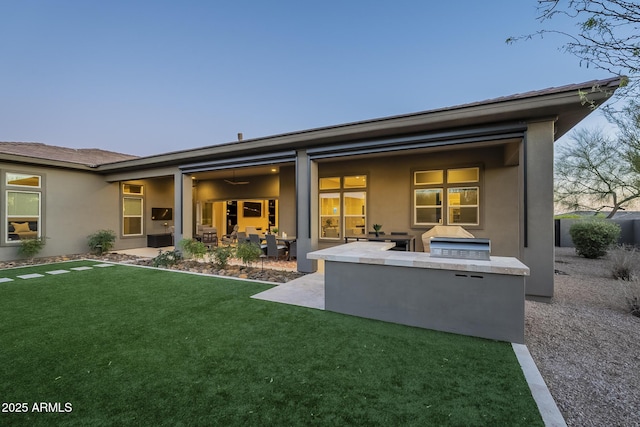 8768 E Granite Pass Rd, Scottsdale, AZ 85266 - rear view of house with stucco siding, exterior kitchen, a patio area, and a yard