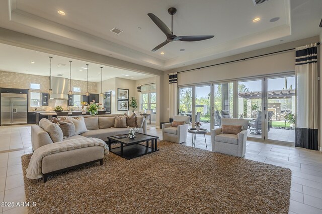 8768 E Granite Pass Rd, Scottsdale, AZ 85266 - living area with a tray ceiling, recessed lighting, ornamental molding, ceiling fan, and visible vents