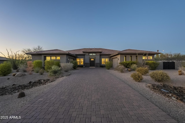 8768 E Granite Pass Rd, Scottsdale, AZ 85266 - prairie-style home with decorative driveway, stucco siding, and a garage