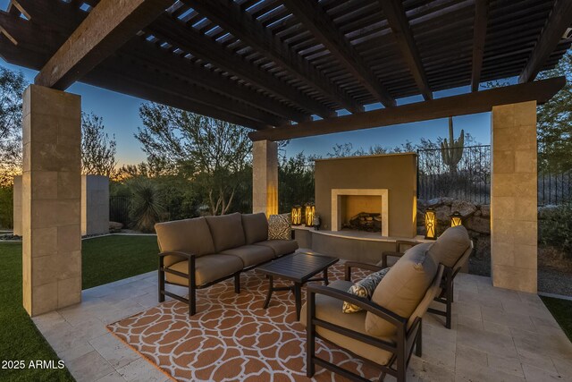 8768 E Granite Pass Rd, Scottsdale, AZ 85266 - patio terrace at dusk with a pergola, an outdoor living space with a fireplace, and fence