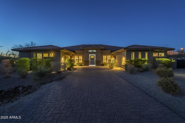 8768 E Granite Pass Rd, Scottsdale, AZ 85266 - prairie-style home featuring stucco siding, a garage, and decorative driveway