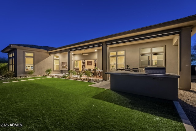 8768 E Granite Pass Rd, Scottsdale, AZ 85266 - rear view of property featuring a lawn, stucco siding, and a patio area