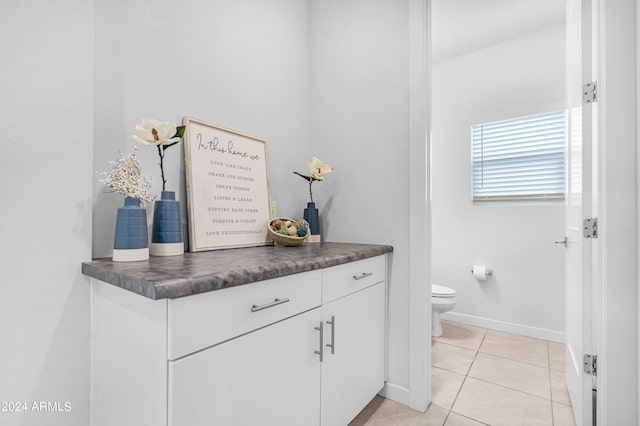 bathroom featuring tile patterned floors, toilet, and vanity