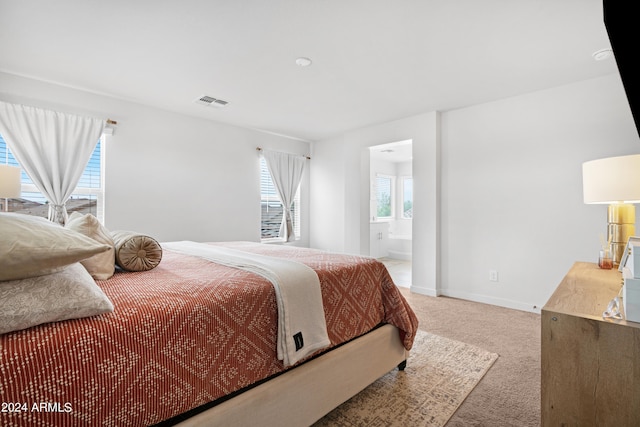 bedroom with carpet and connected bathroom