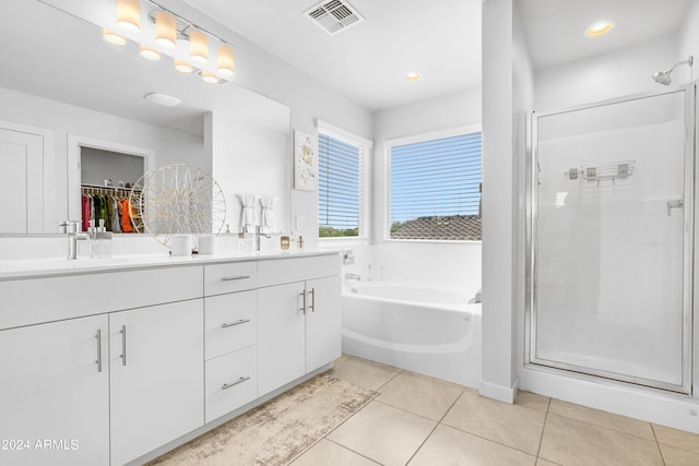 bathroom with tile patterned flooring, shower with separate bathtub, and vanity