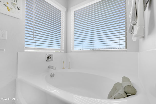 bathroom with a tub to relax in