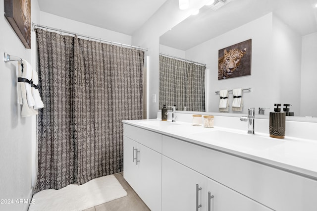 bathroom with tile patterned flooring and vanity