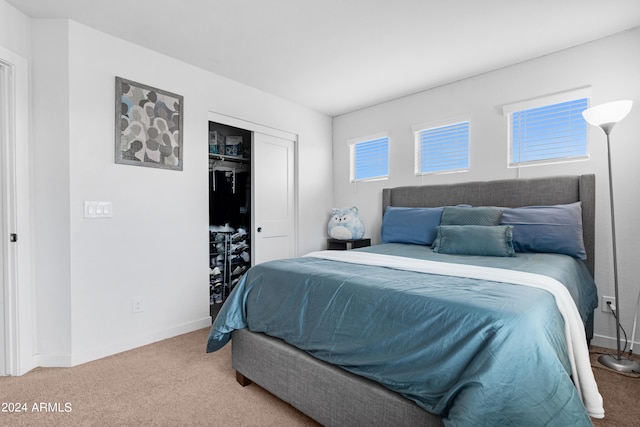 carpeted bedroom with a closet