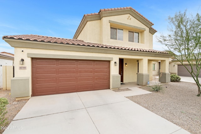 mediterranean / spanish-style home with a garage