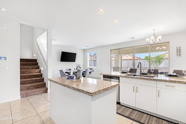 kitchen with a notable chandelier, plenty of natural light, sink, and white cabinets