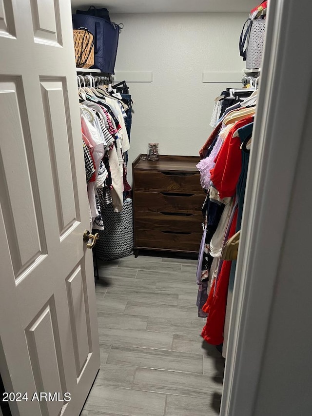 spacious closet with light hardwood / wood-style floors