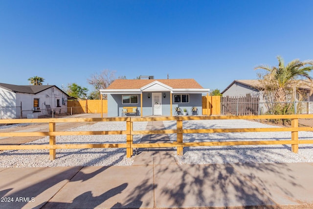 bungalow-style home featuring a fenced front yard