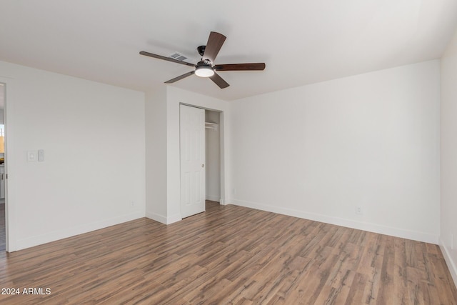 spare room with a ceiling fan, baseboards, and wood finished floors