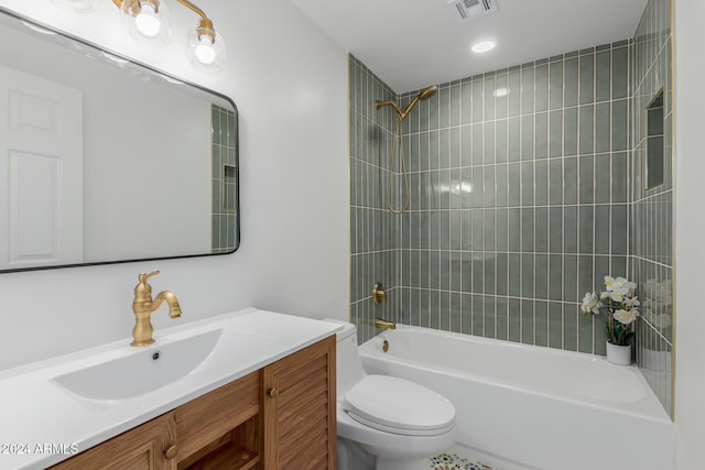 bathroom featuring toilet, vanity, visible vents, and shower / bathtub combination