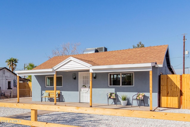 view of front of property featuring cooling unit and covered porch