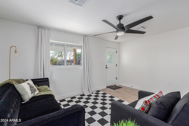 living room featuring light wood-type flooring and ceiling fan