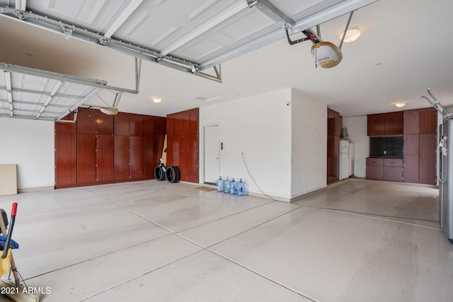 garage with stainless steel fridge