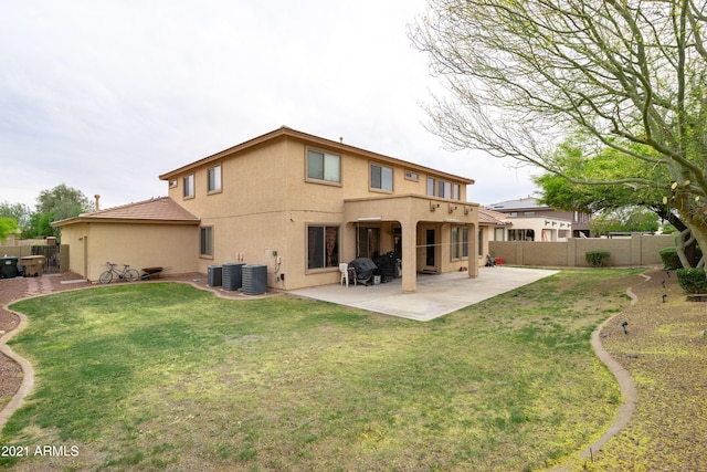 rear view of house with a yard, a patio, and cooling unit