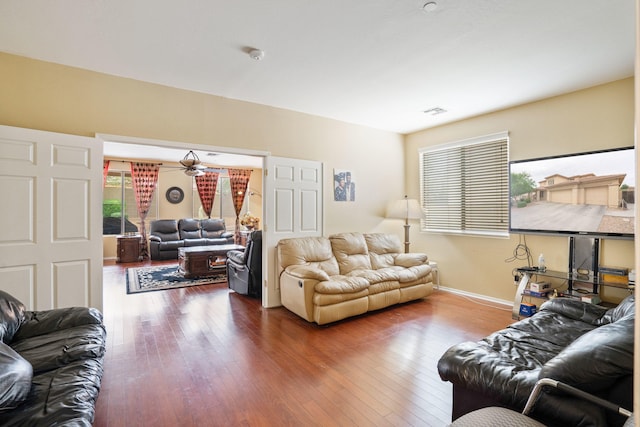 living room with hardwood / wood-style flooring and ceiling fan