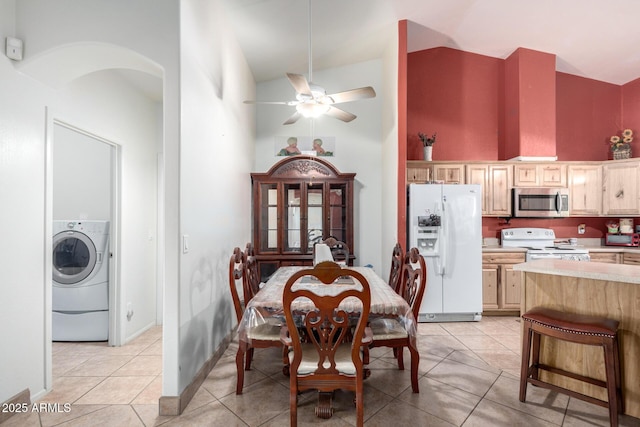 dining area featuring washer / dryer, ceiling fan, light tile patterned flooring, and high vaulted ceiling