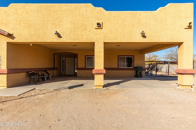 back of property with a patio