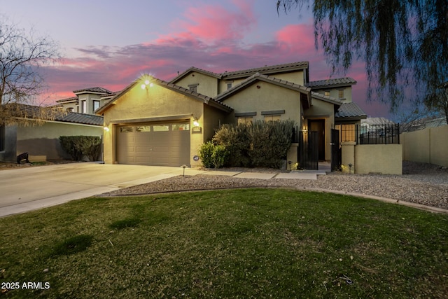 mediterranean / spanish house featuring a garage and a yard