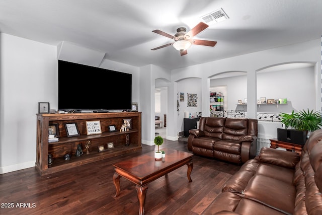 living room featuring ceiling fan and dark hardwood / wood-style flooring