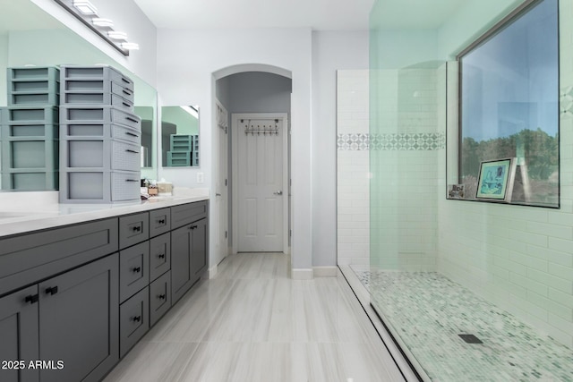 bathroom with walk in shower and vanity