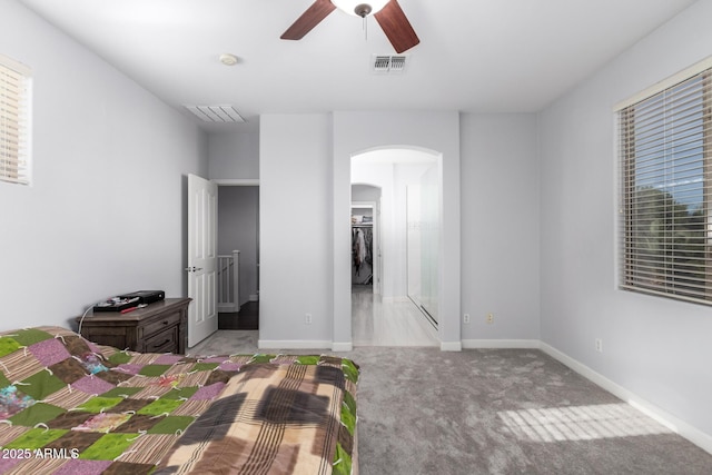 unfurnished bedroom with light colored carpet and ceiling fan