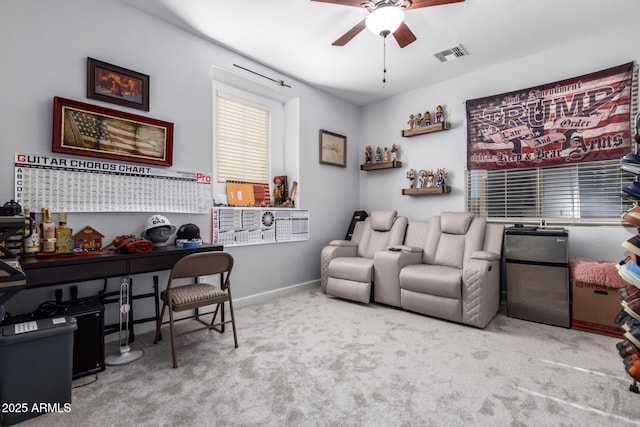 carpeted office space with ceiling fan