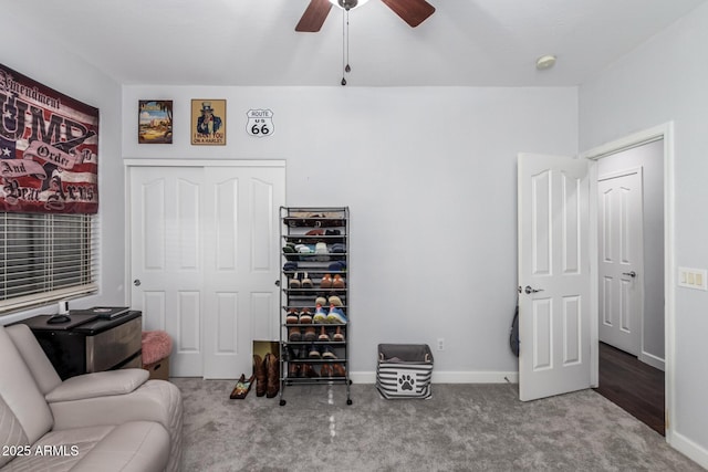 sitting room with ceiling fan and carpet