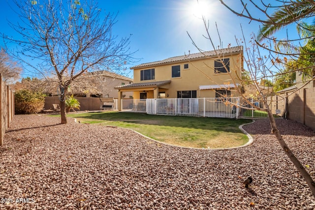 rear view of property featuring a lawn