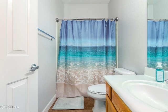 bathroom featuring curtained shower, toilet, and vanity